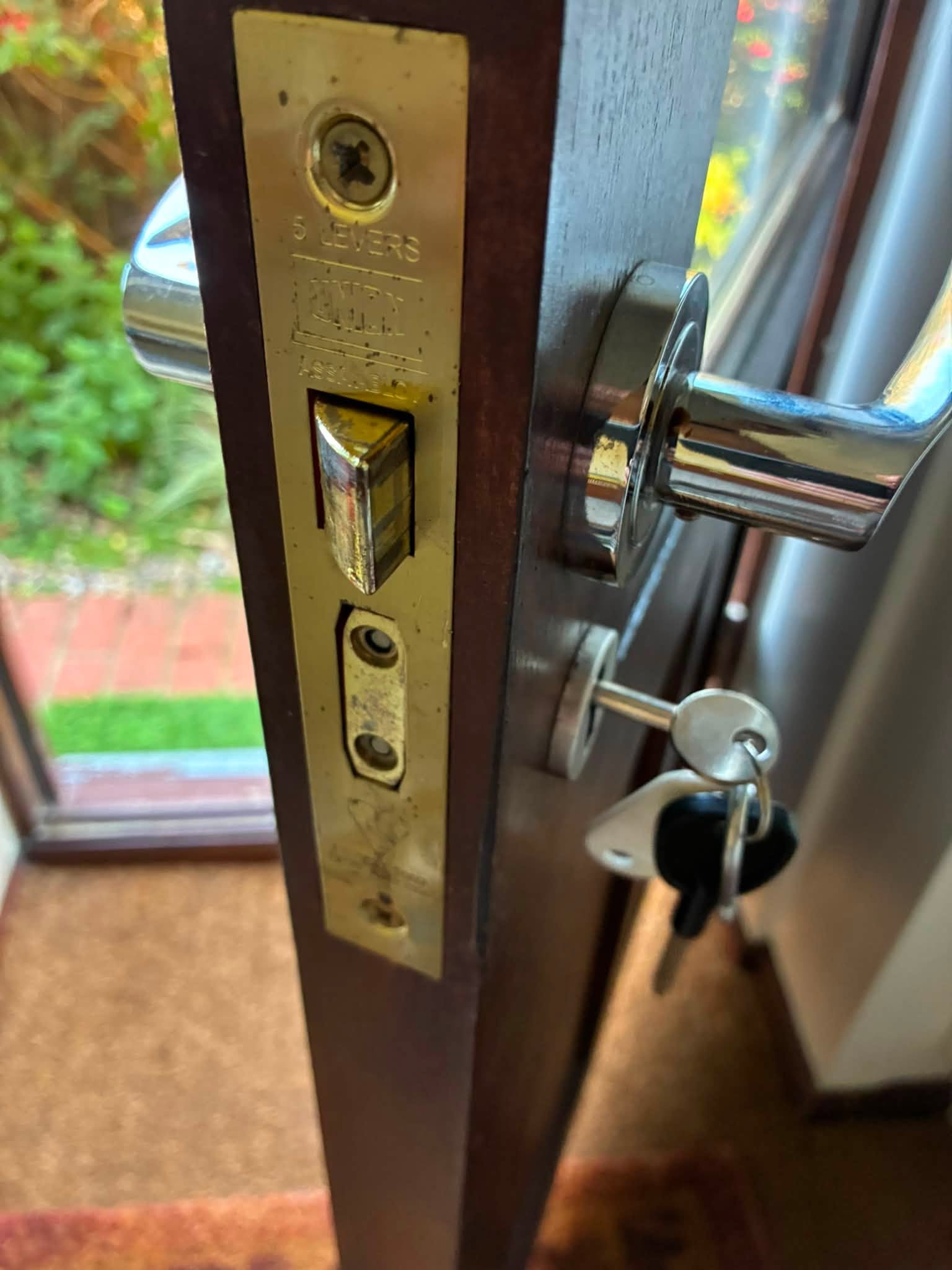 Locksmith repairing damaged door locks in Carrickfergus